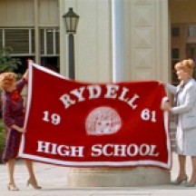 Principal Mrs. McGee raising school flag with assistant Blanche